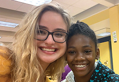 Photo of Diana Toro with a young student
